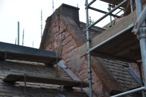 Choir vestry gable with most of concrete stripped. Stone is only 50mm thick in places due to erosion within chimney. Architect advises rebuild better and quicker than pinning