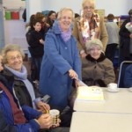 Jeanette cutting the cake celebrating 20 years since her ordination as a minister.