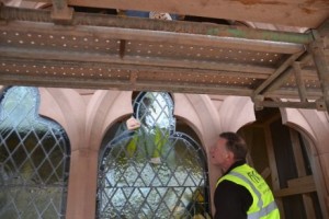 beautiful restored old glass going back into new stone